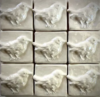 Textured ceramic tiles featuring a relief of birds, arranged in a 3x3 grid. Ideal for decorative design projects or interior decor.